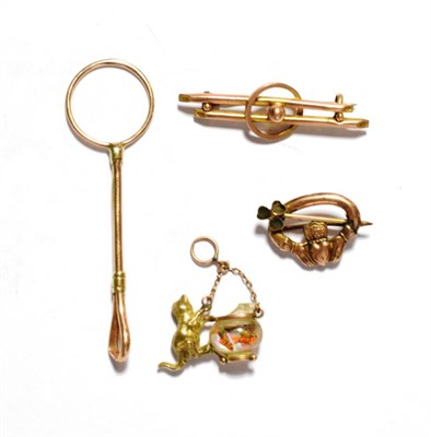 Lot 28 - A 9 carat gold finger ring cigarette holder; two brooches, stamped '9CT'; and a charm stamped '9CT'