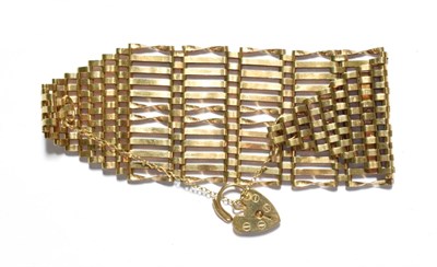 Lot 34 - A 9 carat gold broad gate link bracelet with padlock clasp, length 19cm