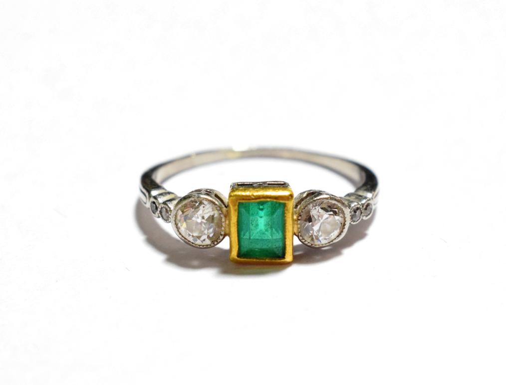 Lot 46 - An emerald and diamond three stone ring with diamond set shoulders (shank worn), finger size N