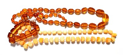 Lot 50 - A faceted graduated amber bead necklace, length 91cm; an amber simulant bracelet; two pairs of...
