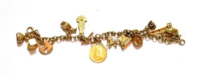 Lot 76 - A charm bracelet, clasp stamped '9CT', hung with fifteen charms including a 1/2 pond coin, a 9...