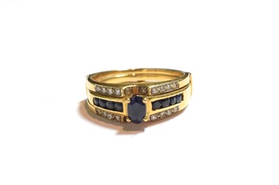 Lot 77 - A sapphire and diamond dress ring, stamped '750', finger size N1/2