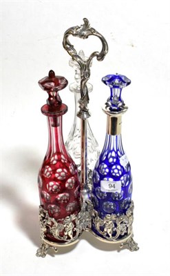 Lot 94 - A silver plated three bottle decanter stand, the blue decanter with a silver collar