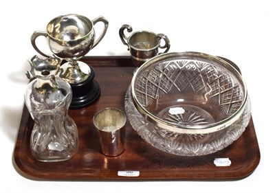 Lot 96 - Silver rimmed bowl, white metal beaker, two trophy cups and a silver mounted decanter