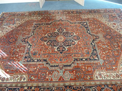 Lot 1098 - Heriz Carpet Persian Azerbaijan The madder field of angular vines around an indigo and salmon...