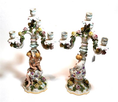 Lot 134 - A pair of Continental floral encrusted four-light candelabra