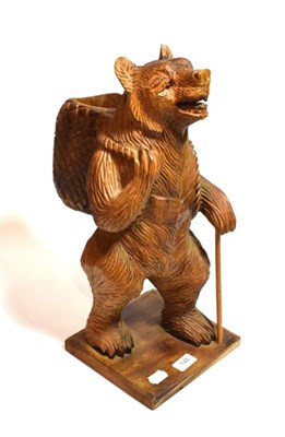 Lot 148 - A modern carved Austro-German figure of a standing bear carrying a basket, 47cm high