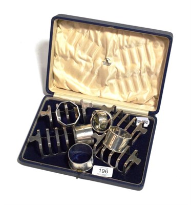 Lot 196 - A cased set of four silver toast racks retailed by Mappin & Webb and six mixed silver napkin rings