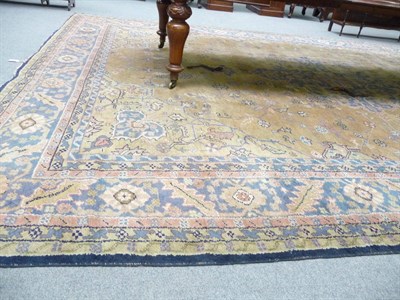 Lot 1108 - Ushak Carpet West Anatolia The tan field of angular vines around a stepped blue grey medallion...