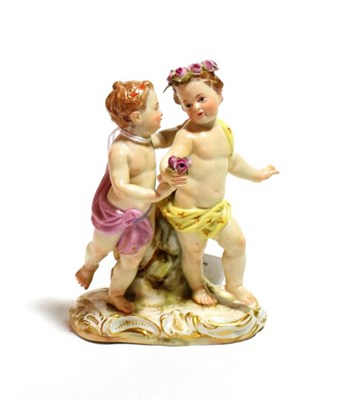 Lot 214 - A Meissen porcelain figure group, late 19th century, as a pair of children dancing, on a scroll...