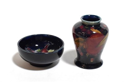 Lot 221 - A William Moorcroft pomegranate pattern miniature vase 9cm; and a modern Moorcroft pin dish (2)