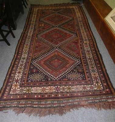 Lot 1112 - Luri Carpet West Persia The polychrome field with a column of latch hook medallions enclosed by...