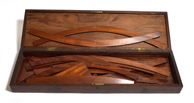 Lot 257 - Draftsmans set of teak curves and set squares no graduations or other labelling, in mahogany case