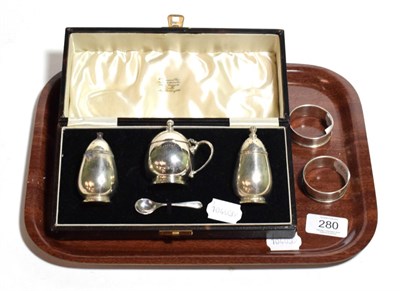 Lot 280 - An Art Deco silver three-piece cruet set, of stylised form, W.G & S, Birmingham, 1936; together...