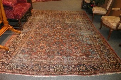 Lot 1118 - Mahal Carpet West Persia The brick red field with an allover Herati design enclosed by indigo...