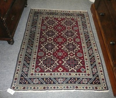 Lot 1119 - Lesghi Rug  East Caucassus The blood red field with two rows of typical stellar motifs enclosed...