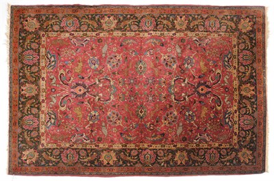 Lot 1130 - Isfahan Design Rug  Probably Central Persia The raspberry field of palmettes, scrolling vines...