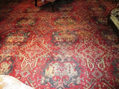 Lot 1131 - Ushak Carpet Central Anatolia The soft claret field with columns of medallions enclosed by multiple