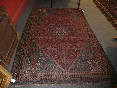 Lot 1135 - Kashgai Rug South West Persia The madder diamond shaped field of stylised plants and leaves...