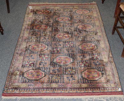 Lot 1175 - Afghan silk rug, the compartmentalised field of flower heads and octagons enclosed by borders...