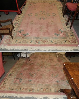 Lot 1180 - Chinese carved carpet, the candy pink field of Taoist motifs centred by a roundel framed by...