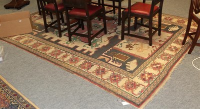 Lot 1184 - A Turkish carpet, the charcoal field centred by a large ivory panel and angular medallion,...