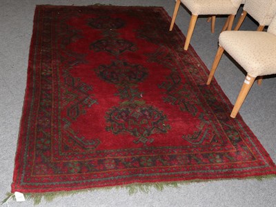 Lot 1191 - An Ushak Carpet, the tomato red field with a column of medallions enclosed by rosette borders,...