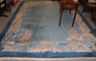Lot 1192 - A Chinese carpet, the pale indigo field of leafy lattice design enclosed by spandrels and pictorial