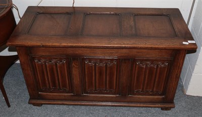 Lot 1204 - A reproduction oak line fold chest with hinged lid, 107cm wide