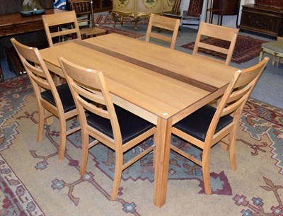 Lot 1221 - A modern solid oak dining table, 160cm wide; and six ladder back chairs with brown leather seats