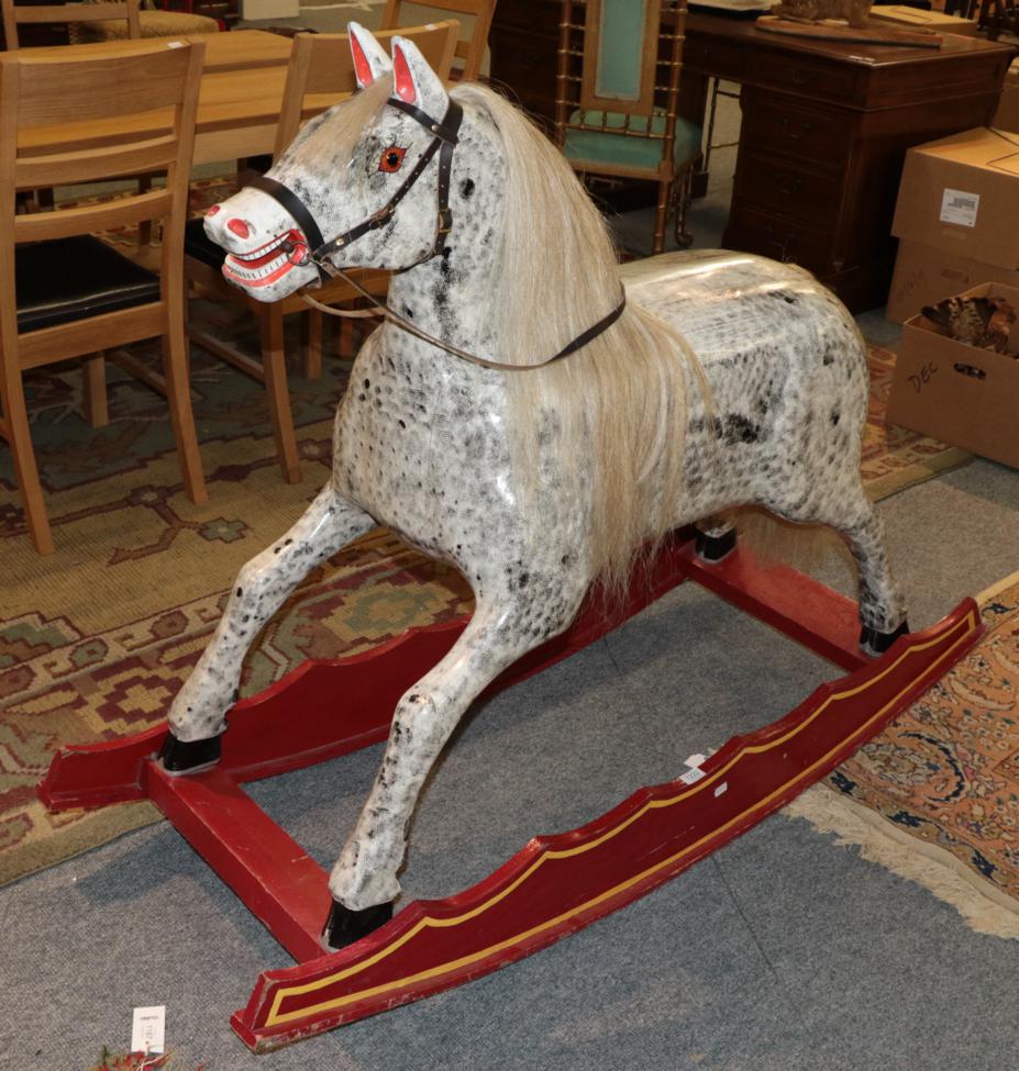 Lot 1222 - A mid-20th century dapple grey rocking horse on a wide rocking treadle base