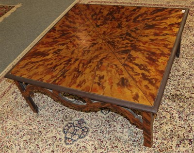Lot 1226 - A faux tortoiseshell painted coffee table, of square form with pierced apron, on square...