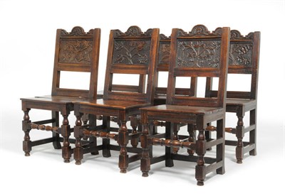 Lot 1145 - A Set of Six Victorian Carved Oak Backstools, each with shaped and carved top rails above a...