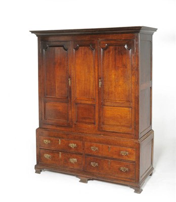 Lot 1148 - A George III Oak Press Cupboard, late 18th century, the later pediment above conforming fielded...