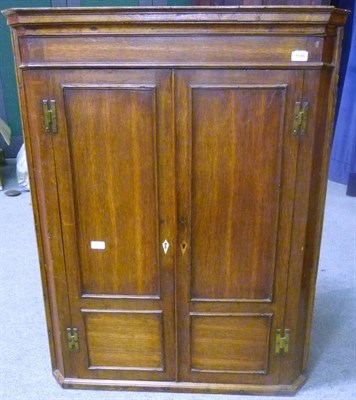 Lot 1149 - An 18th Century Oak Hanging Corner Cupboard, with conforming fielded panel door and H hinges...