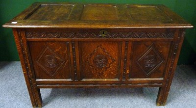 Lot 1151 - A Joined Oak Chest with Hinged Lid, the carved frieze with three fielded panels inlaid and...