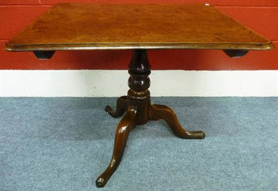 Lot 1152 - A George III Oak Tripod Pedestal Table, the rectangular tilt-top raised on a turned support...