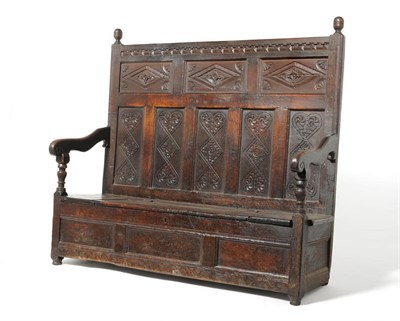 Lot 1155 - A Late 17th Century Joined Oak Box Settle, the fielded panel back with carved lozenge and...