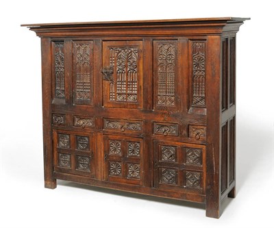 Lot 1162 - An Oak Gothic Style Aumbry, the upper section with five heavily carved Gothic tracery panels, three