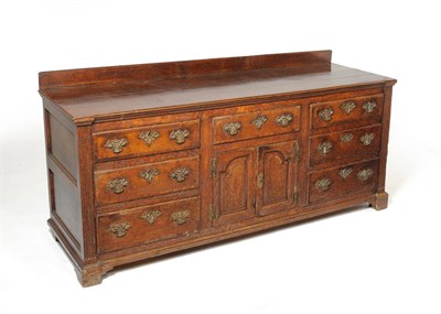 Lot 1168 - An Oak and Mahogany Crossbanded Enclosed Low Dresser, with an arrangement of six deep drawers...