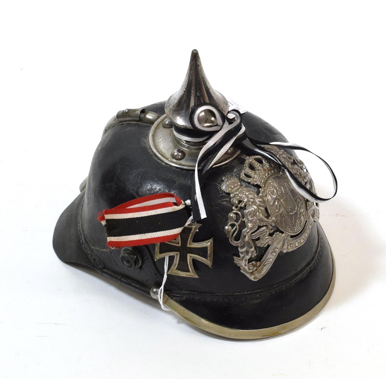 Lot 101 - A Bavarian EM's Black Leather Pickelhaube, with white metal conical spike, rib with sliding...