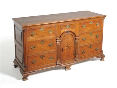 Lot 1169 - A George II Oak Lancashire Enclosed Dresser, mid 18th century, with an arrangement of six...