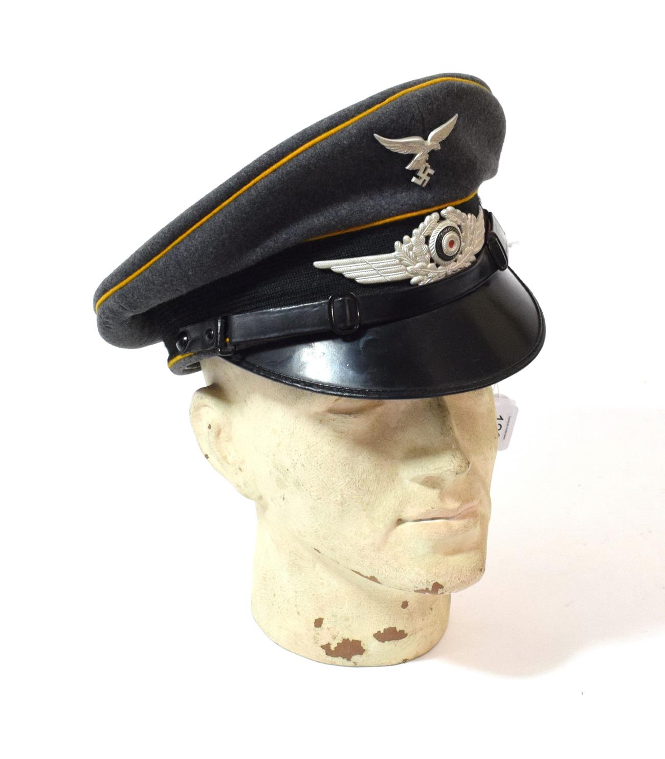 Lot 128 - A German Third Reich Luftwaffe EM/NCO's Visor Cap, in blue/grey wool, with mustard waffenfarbe,...