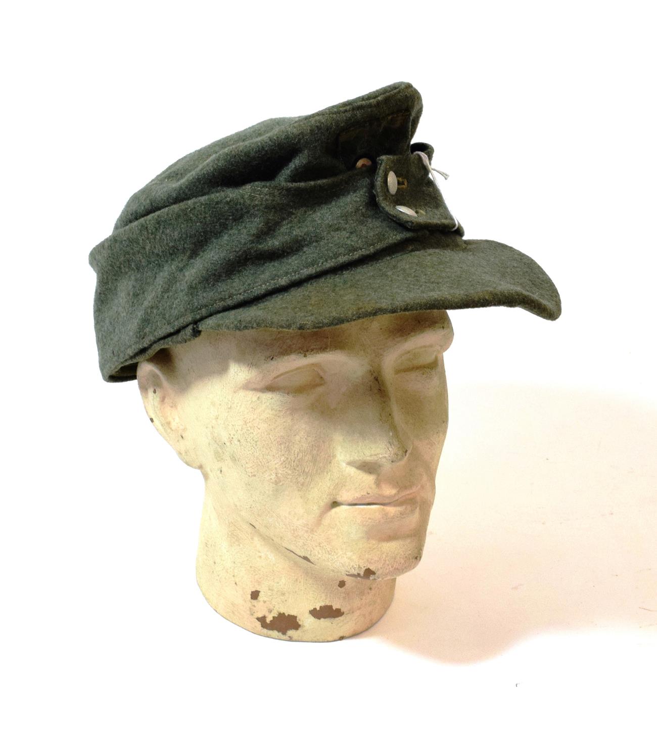 Lot 130 - A German Third Reich Heer EM/NCO's M34 Field Cap, in green wool, the front stitched with a...