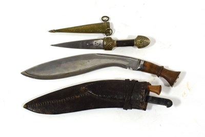 Lot 140 - A Kukri, with chromed steel blade, bolster and wood grip, with leather sheath; a Small Kindjal,...