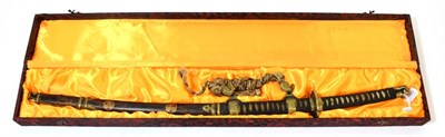 Lot 153 - A Japanese Showa Tachi, the 66cm blade with billowing hamon, signed tang, one piece brass...