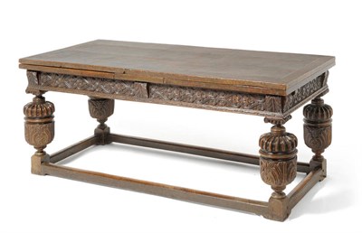 Lot 1175 - An Elizabethan Carved Oak Knock-down Refectory Dining Table, the  cleated top above replaced...