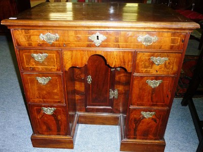 Lot 1179 - A George II Figured Walnut Kneehole Dressing Table, the moulded top above a single frieze...