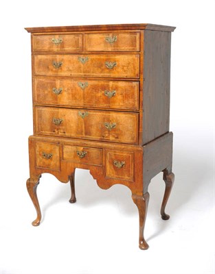 Lot 1180 - A George II Walnut, Featherbanded and Pine Sided Chest on Stand, with two short over three long...