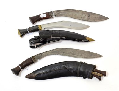 Lot 248 - Two Nepalese Kukri, each with broad curved steel blade with double fullered back edge, steel...